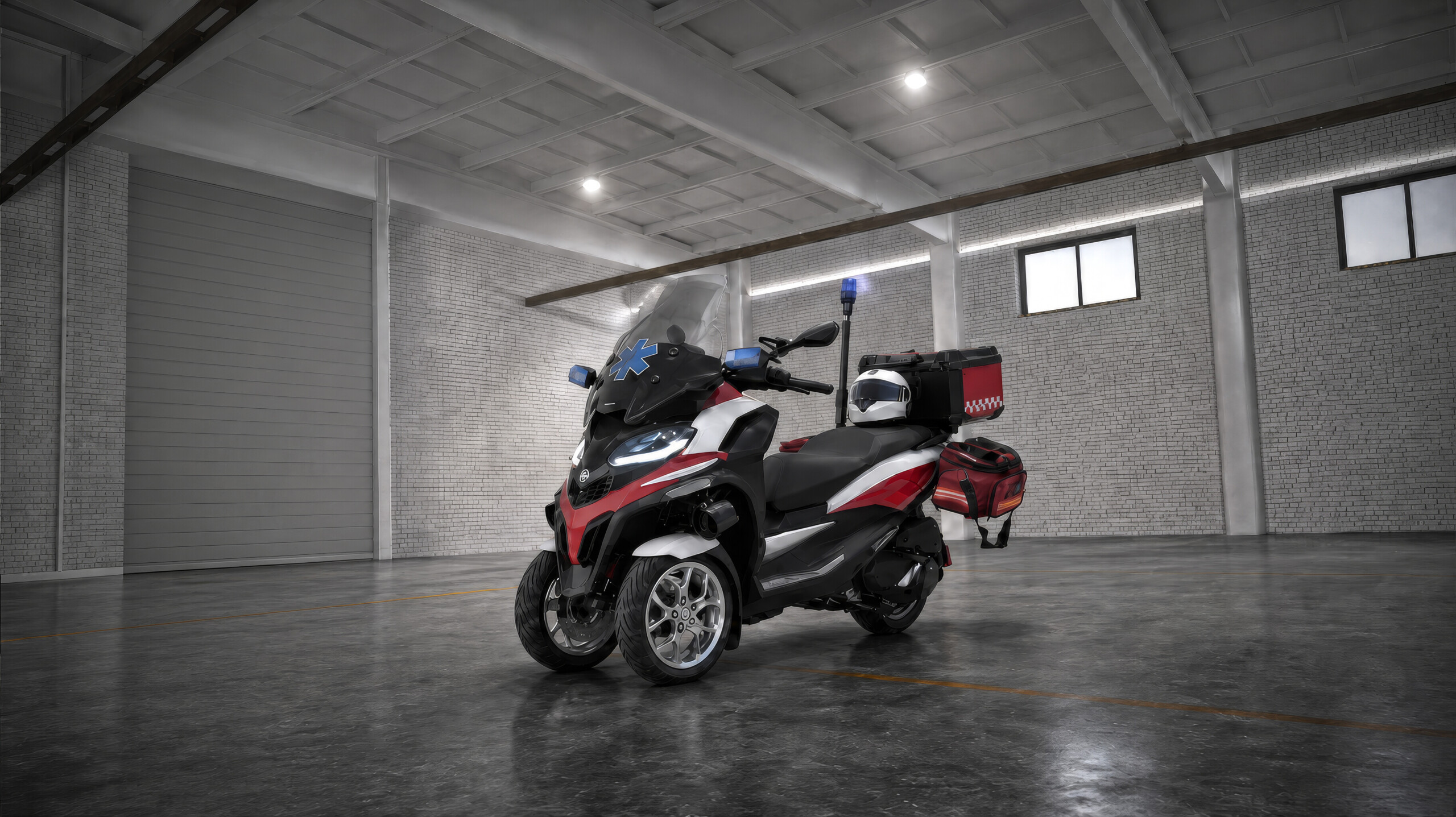 A red and white delivery scooter parked in a spacious warehouse setting.
