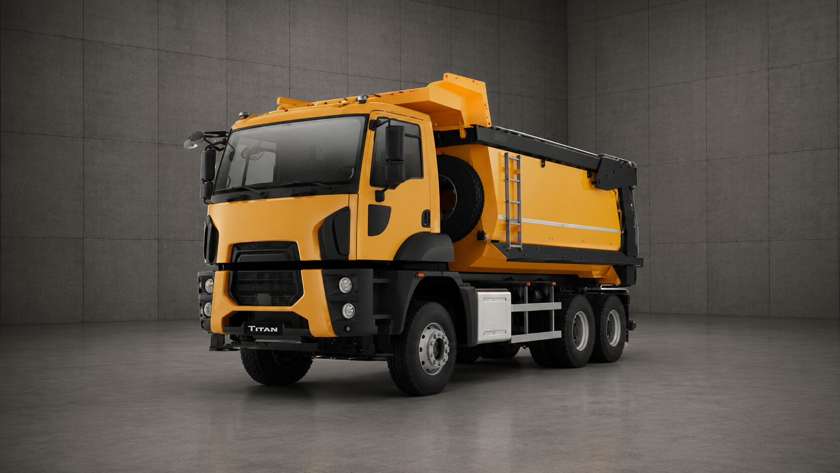 A yellow and black Titan dump truck parked in a gray room, showcasing its distinctive features.