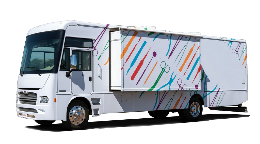 A white RV with colorful stripes and circles on the side, set against a black background.